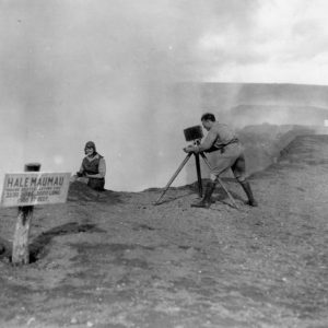 Photographer and man at volcano edge.