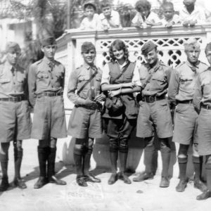 Group of soldiers posing with a woman.