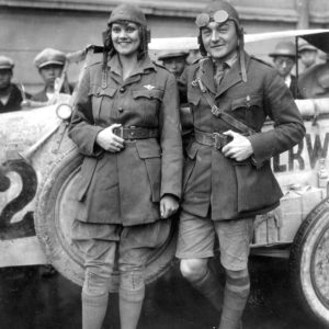 Two people in vintage racing attire.