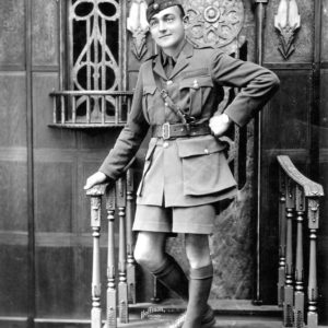 Man in military uniform posing on staircase.